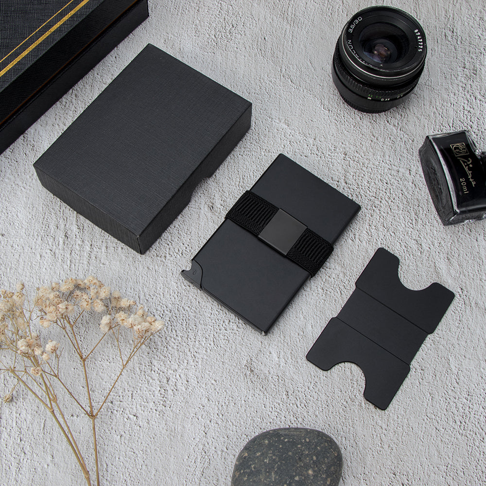 Black pop-up wallet unpacked beside its gift box