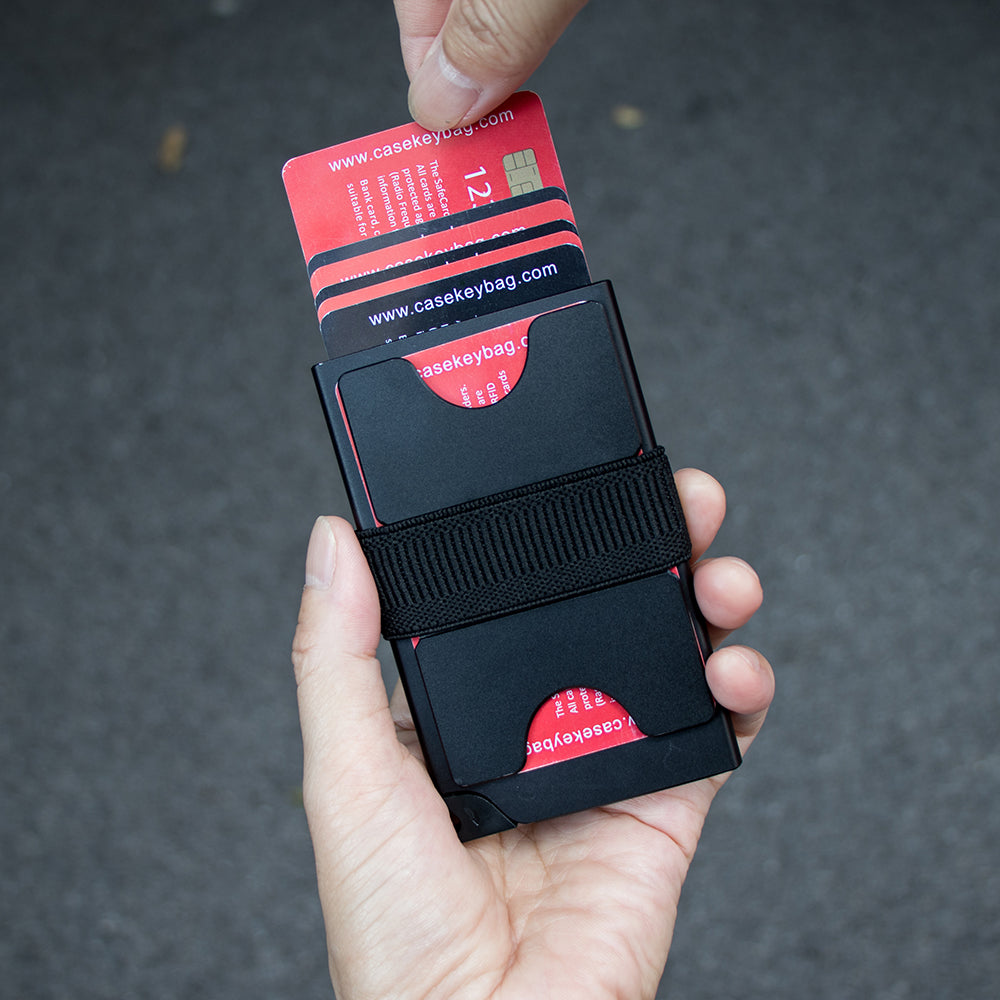 Hand sliding cards out of the pop-up wallet